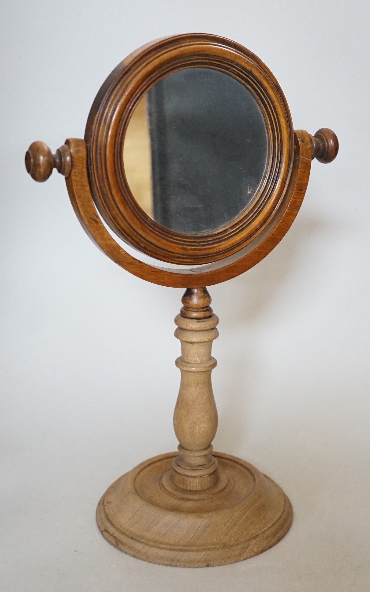 A Victorian turned wooden shaving mirror, 37cms high